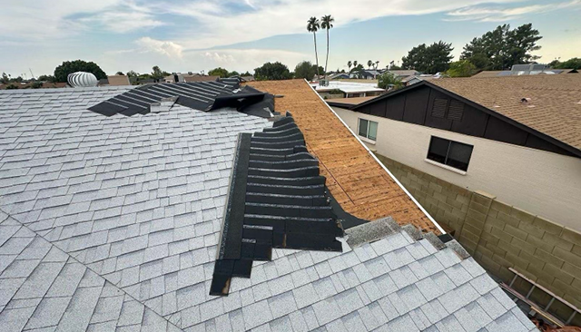 Roof with tiles pealed back in repair